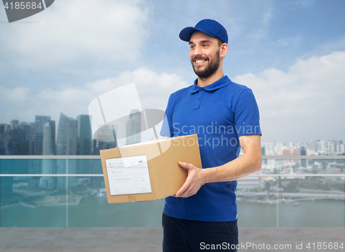 Image of happy delivery man with box over singapore city