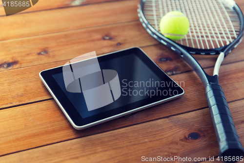 Image of close up of tennis racket with ball and tablet pc