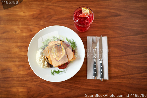 Image of close up of fish salad with roasted lemon on plate