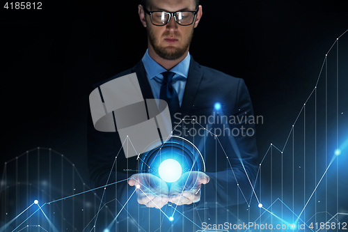 Image of businessman with virtual diagram chart projection