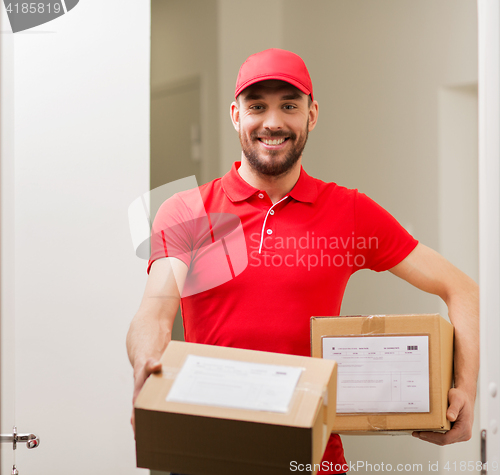 Image of delivery man with parcel boxes at customer door