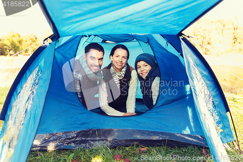 Image of happy family with tent at camp site