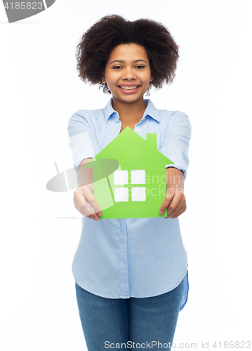 Image of happy african american woman with green house icon