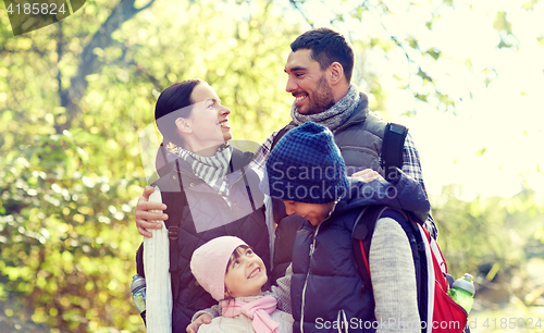 Image of happy family with backpacks hiking