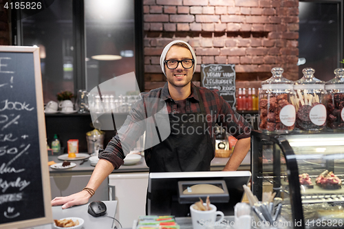 Image of happy seller man or barman at cafe counter