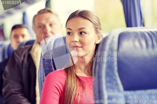 Image of happy young woman sitting in travel bus or train