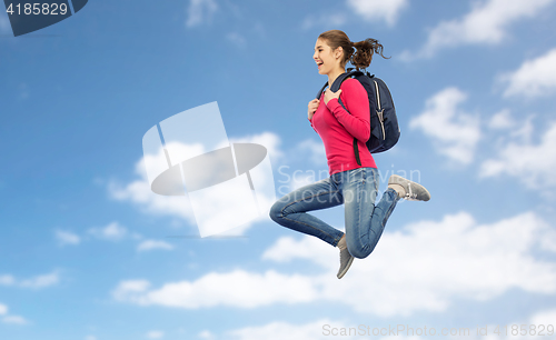 Image of happy woman or student with backpack jumping