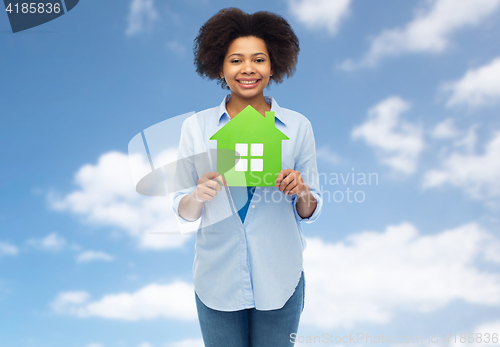 Image of happy african american woman with green house icon