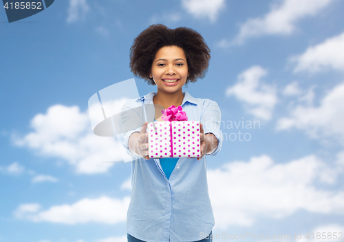 Image of happy african woman with birthday gift box