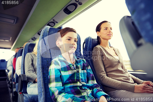 Image of happy family riding in travel bus