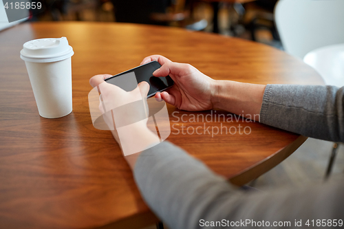 Image of close up of woman with smartphone and coffee