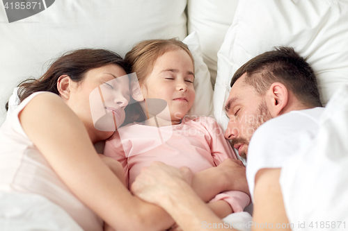 Image of happy family sleeping in bed at home