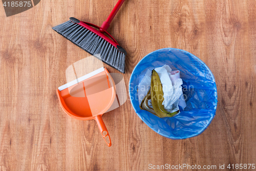 Image of rubbish bag with trash and cleaning items at home