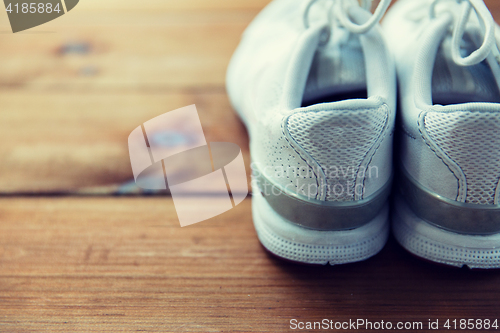 Image of close up of sneakers on wooden floor