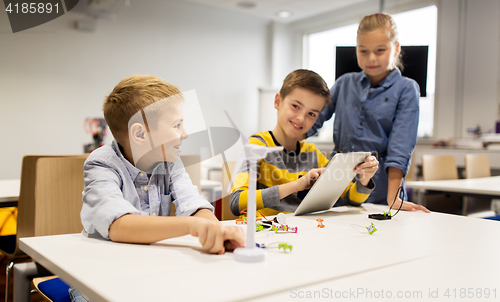 Image of kids with tablet pc programming at robotics school