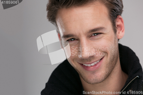 Image of portrait of a young guy over gray background