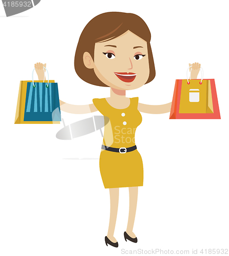 Image of Happy woman holding shopping bags.