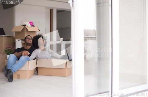 Image of African American couple  playing with packing material