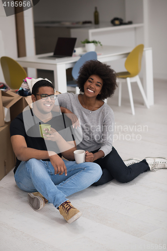 Image of African American couple relaxing in new house