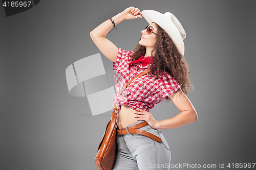 Image of The cowgirl fashion woman over a gray background