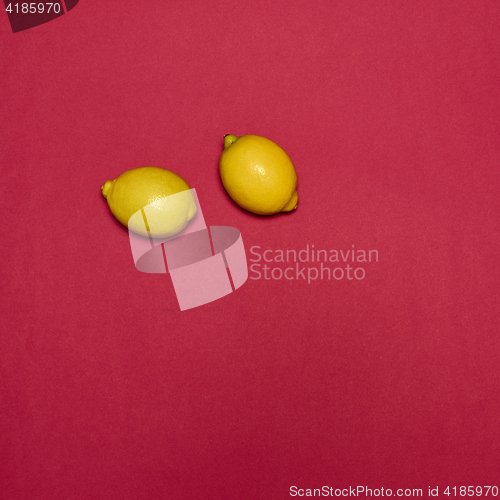 Image of Lemons on red background