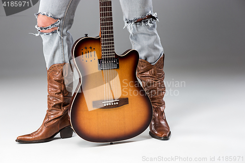 Image of Legs in Jeans and Cowboys Boots