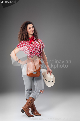 Image of The cowgirl fashion woman over a gray background