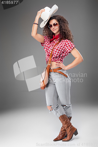 Image of The cowgirl fashion woman over a gray background