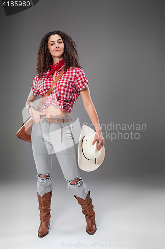 Image of The cowgirl fashion woman over a gray background