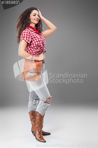 Image of The cowgirl fashion woman over a gray background