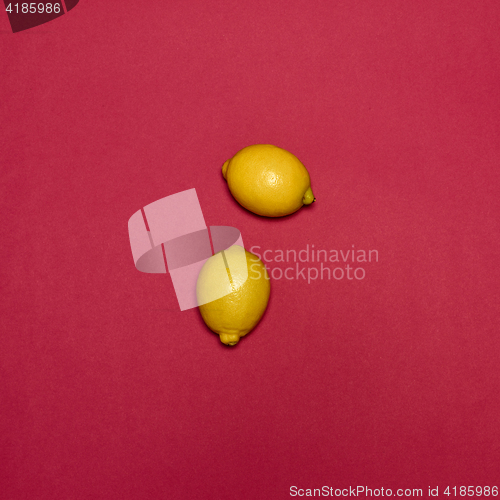 Image of Lemons on red background