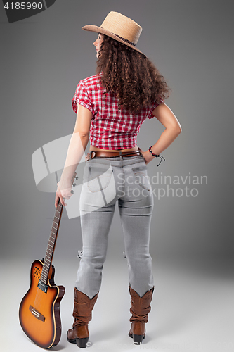 Image of The cowgirl fashion woman over a gray background