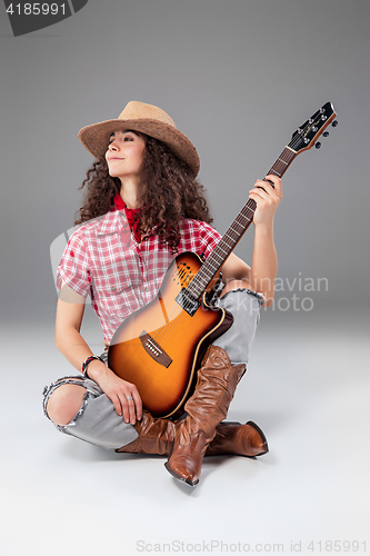 Image of The cowgirl fashion woman over a gray background