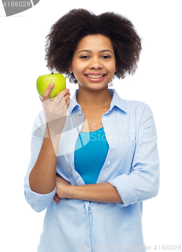 Image of happy african american woman with green apple