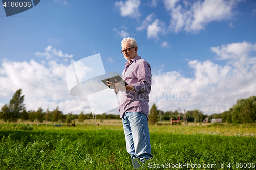 Image of senior man with tablet pc computer at county