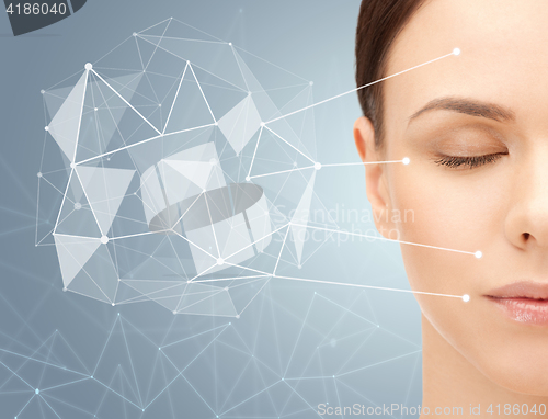 Image of beautiful woman half face with low poly projection