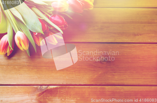 Image of close up of tulip flowers on wooden table