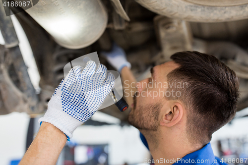 Image of mechanic man or smith repairing car at workshop