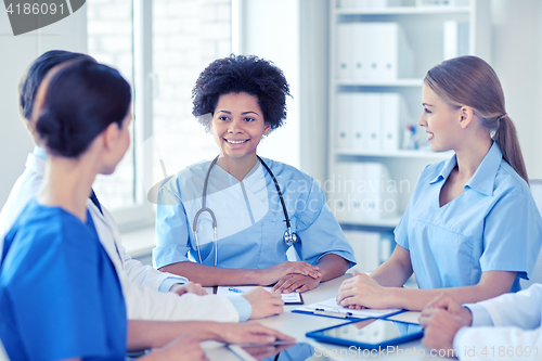 Image of group of happy doctors meeting at hospital office