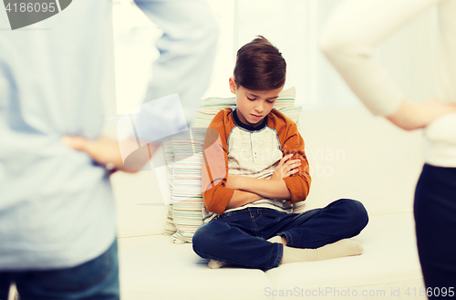 Image of upset or feeling guilty boy and parents at home