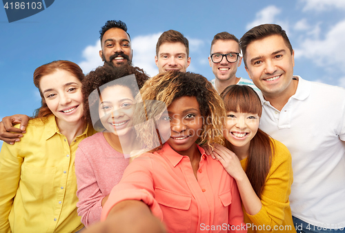 Image of international group of happy people taking selfie