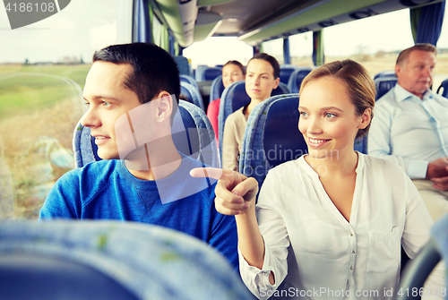 Image of happy couple or passengers in travel bus