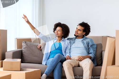 Image of happy couple with boxes moving to new home