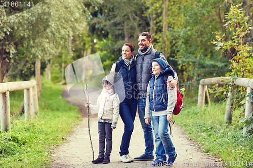 Image of happy family with backpacks hiking