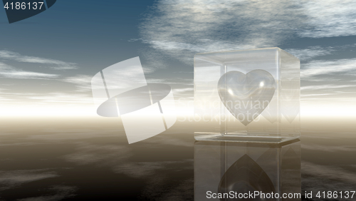 Image of heart symbol in glass cube under cloudy sky - 3d rendering