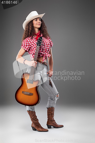 Image of The cowgirl fashion woman over a gray background