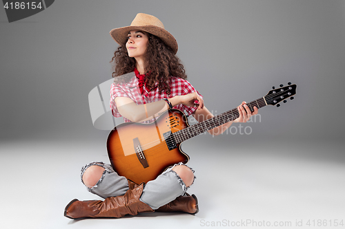 Image of The cowgirl fashion woman over a gray background