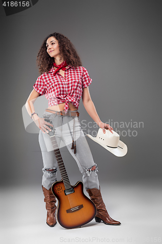 Image of The cowgirl fashion woman over a gray background