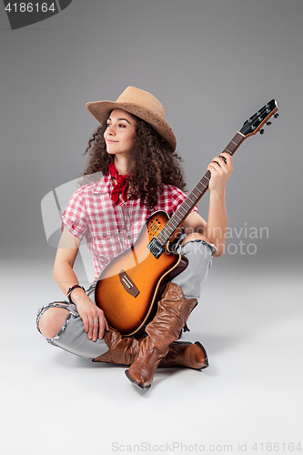 Image of The cowgirl fashion woman over a gray background