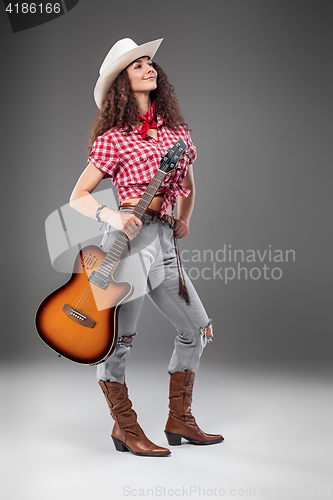 Image of The cowgirl fashion woman over a gray background